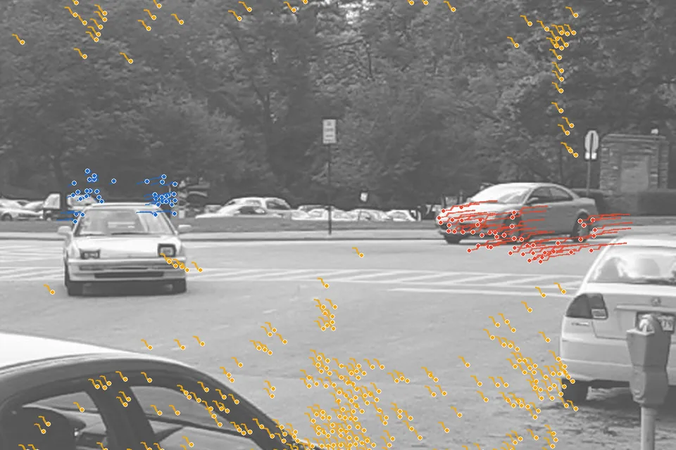 A Hopkins155 street scene with point trajectories coloured by motion: two cars and the background.
